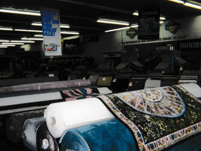 old image of Columbia Rug inside showroom with rolls of rugs